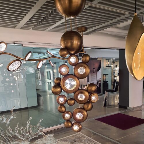 Vertical brass Bubble Chandelier featuring circular light apertures